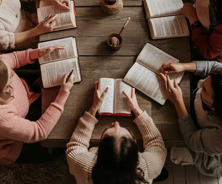 Group of ladies sitting around a table having a bible study discussion